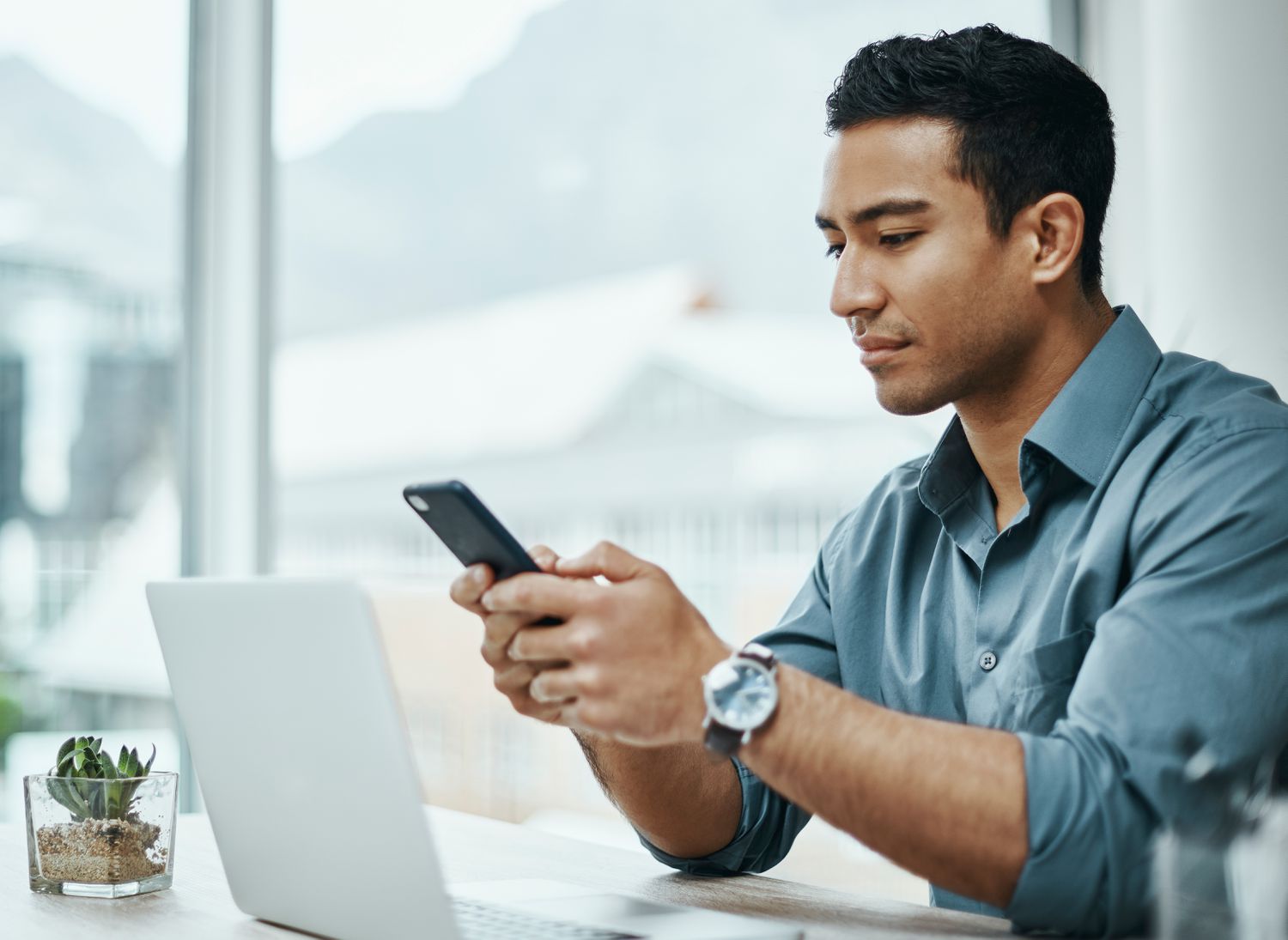Young professional Asian man studying phone and laptop