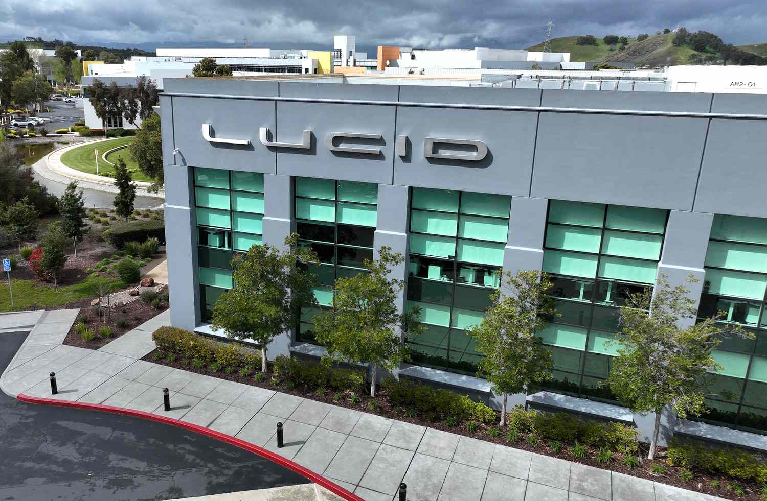 In an aerial view, a sign is posted on the exterior of Lucid headquarters on March 29, 2023 in Newark, California. 