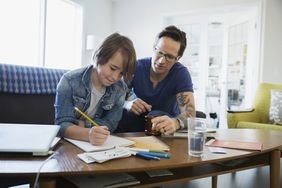 Kid working on homework with parent