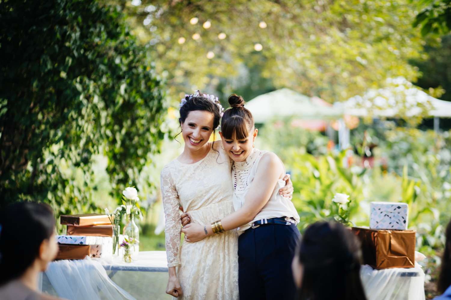 Lesbian couple celebrating at wedding with gifts