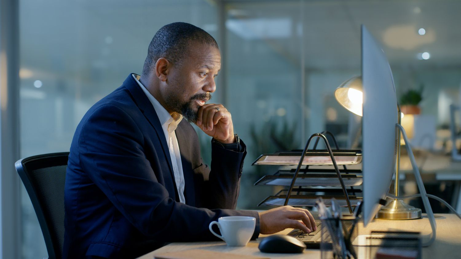 A portfolio manager works at night as they research possible investments for the fund they manage.