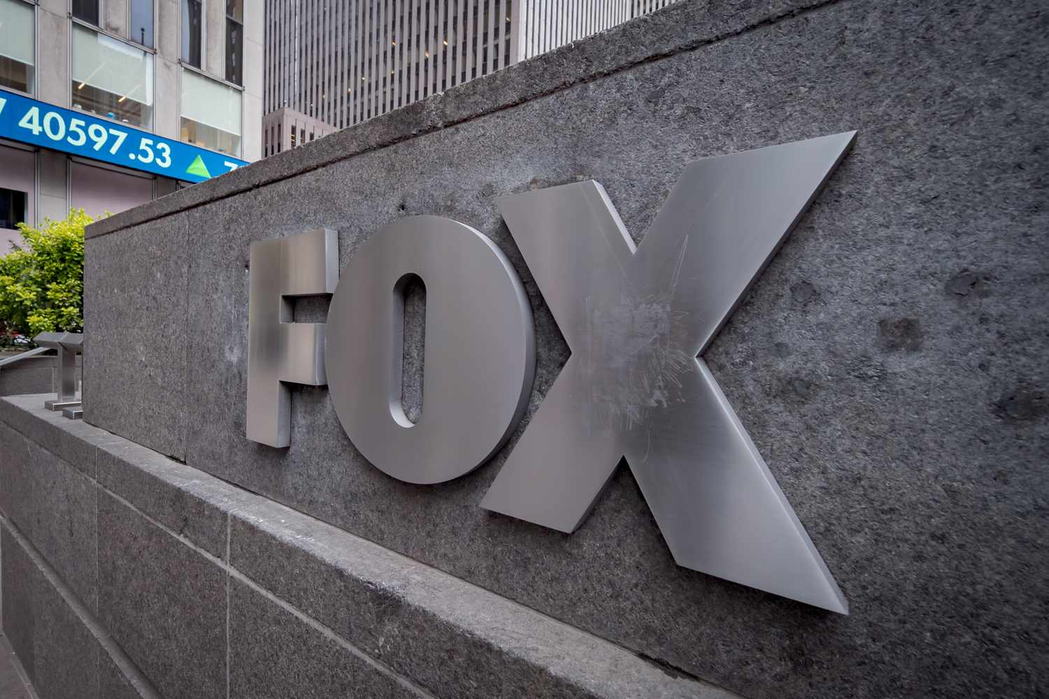 The Fox logo is seen on a sign next to buildings in New York City.