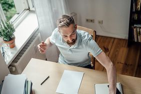 Man at desk in home