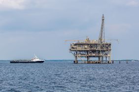 A ship approaches an Exxon Mobil oil rig in the Gulf of Mexico.