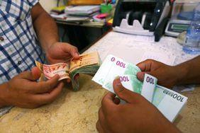 Close up of hands exchanging bank notes at a currency exchange in Tripoli