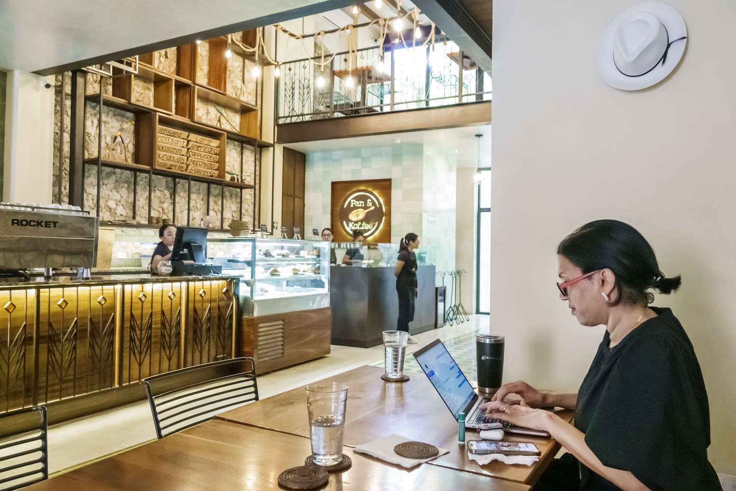 Customer in a coffee shop using a laptop