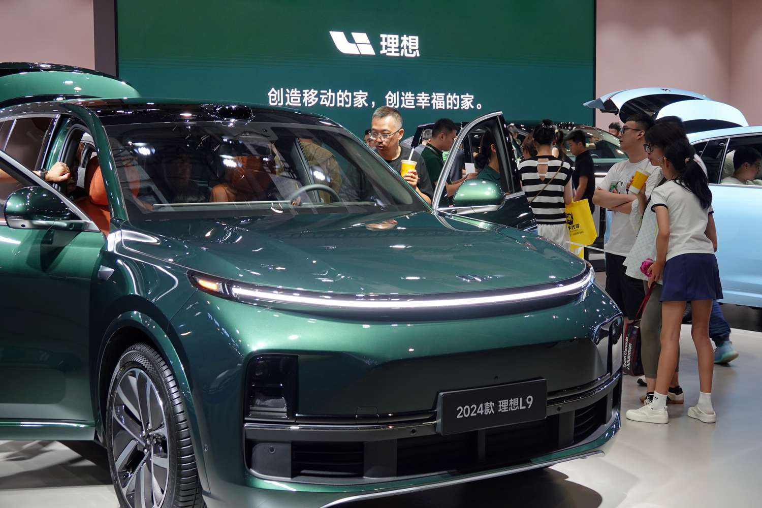 Visitors are looking at the 2024 Li Auto L9 electric car at the 21st Changchun International Automobile Expo in Changchun, Jilin province, China, on July 17, 2024