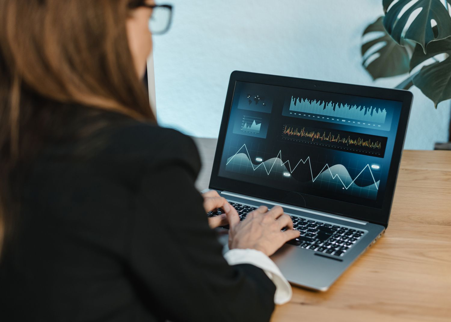 A trader uses a laptop to place stops on a super upside note they have on a long position they hold.