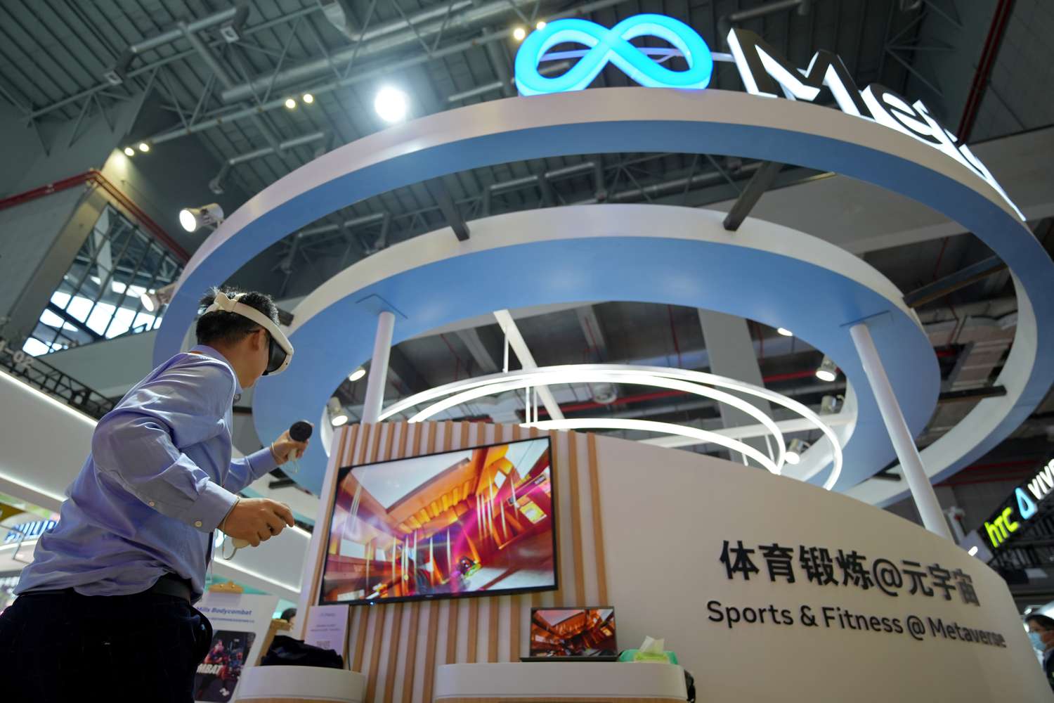 Man wearing a virtual reality headset at the Meta booth at an expo in China