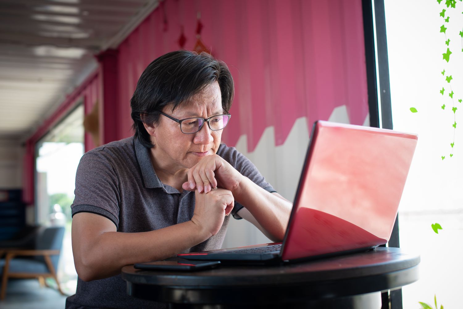 A trader furrows their brow as they study a financial chart on a laptop before setting up the put and call options that will create a synthetic futures contract.
