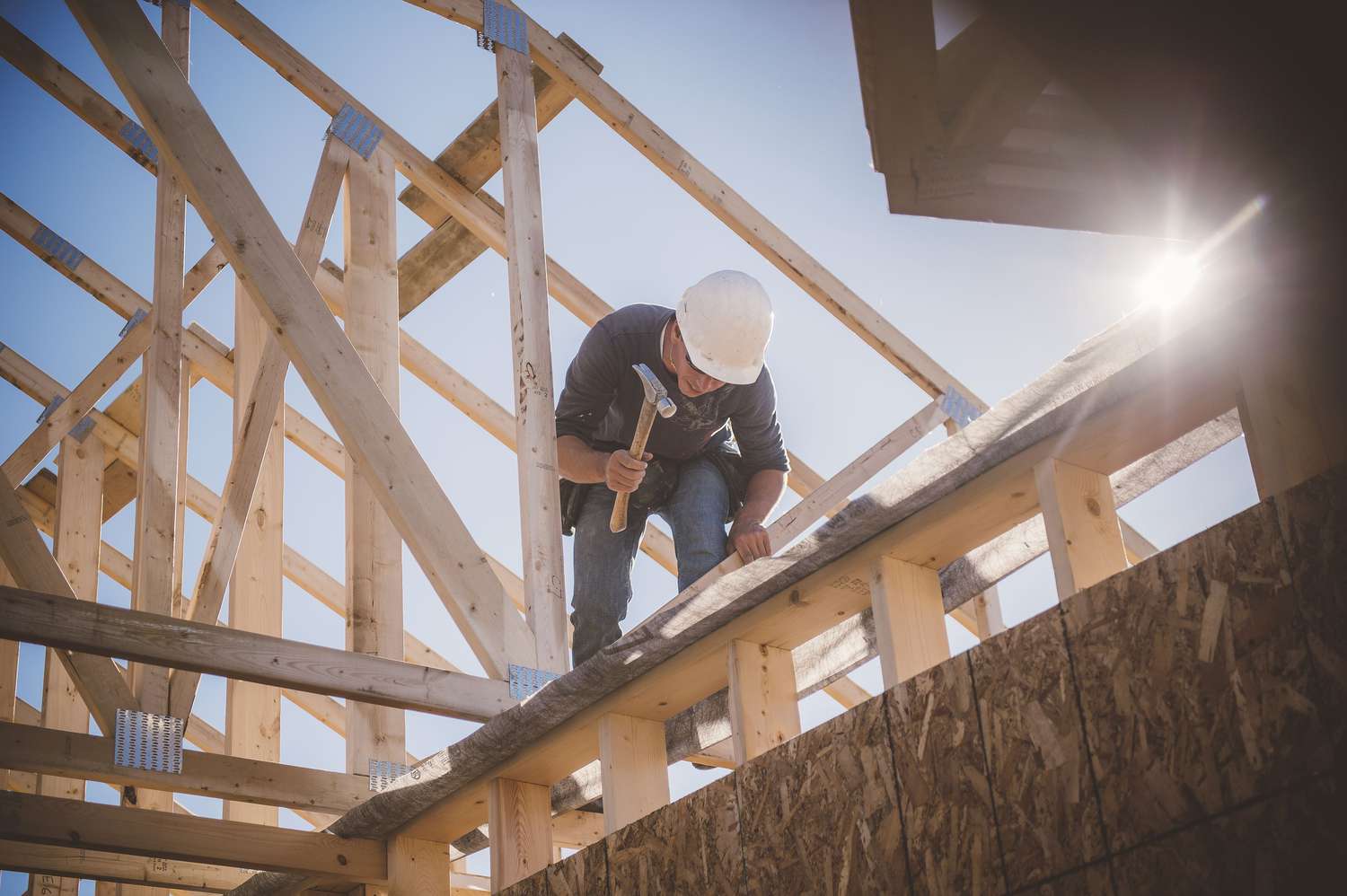 Builder working on the frame of a new house