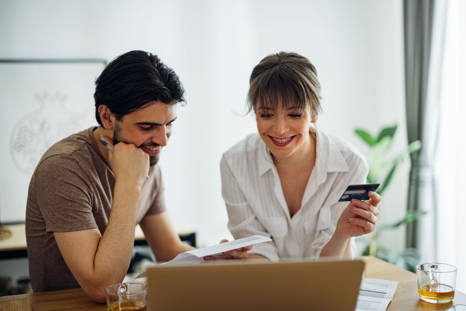 Happy couple paying bills