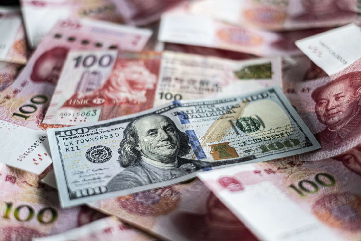 U.S. $100 dollar bill amongst foreign currency. 