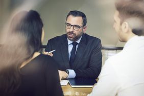A lawyer meets with clients.