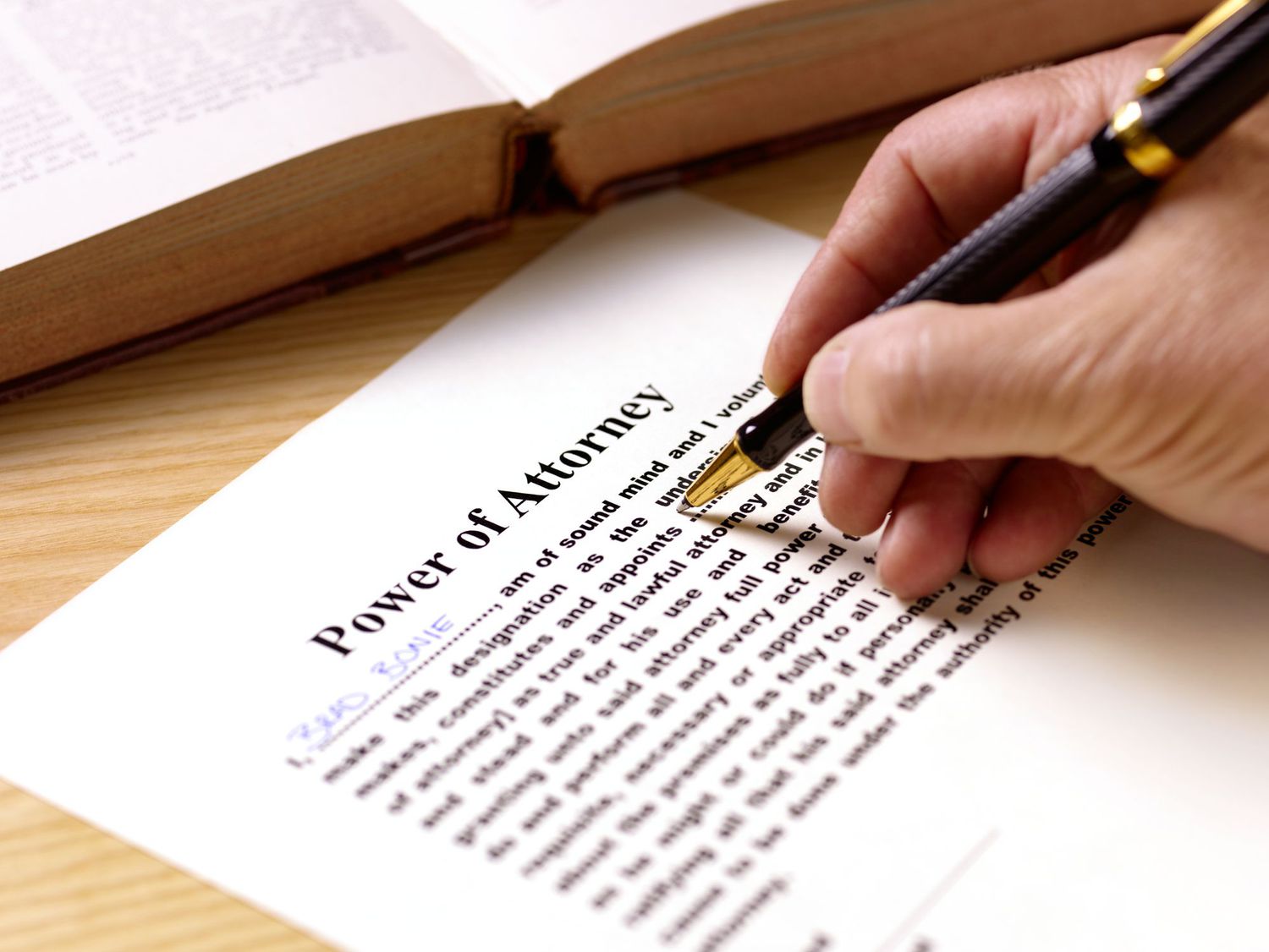 A person signing a power of attorney form