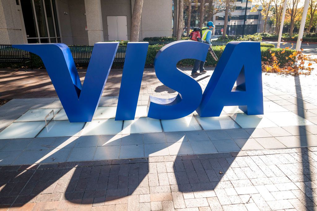 A gardener wearing a protective mask uses a leaf blower outside Visa Inc. headquarters in Foster City, California, U.S., on Monday, Nov. 23, 2020. 