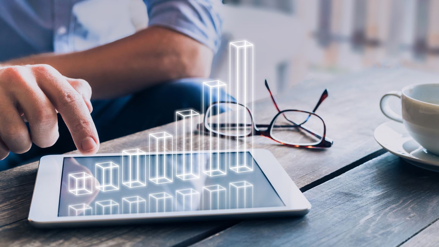 Businessman analyzing growing 3D chart floating above digital tablet computer screen, showing successful increase in business profit.