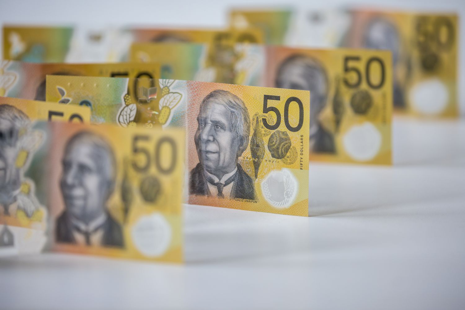 Several $50 Australian bank notes are shown in front of a white background.