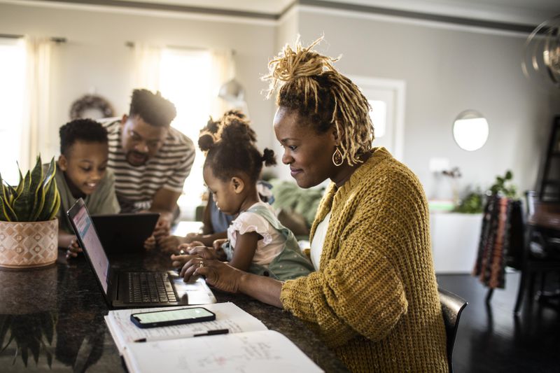 Mother looking up what qualifies as real property while spending time with her family