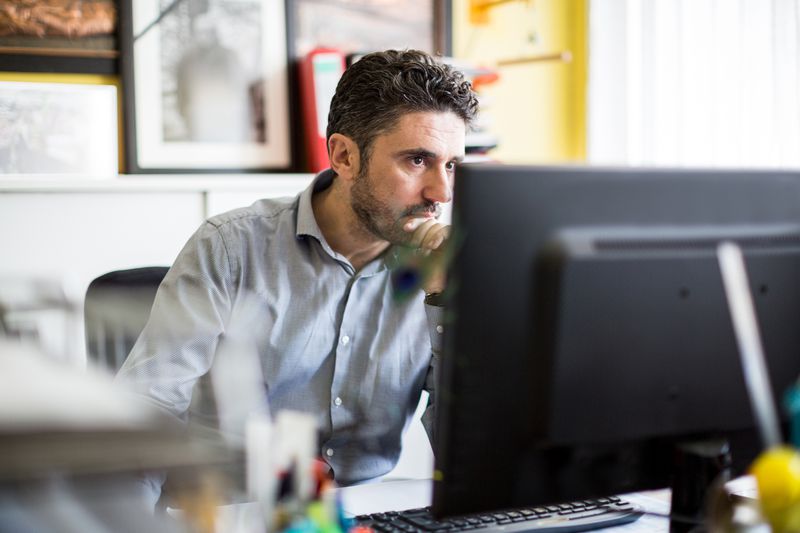 A man uses a desktop computer.