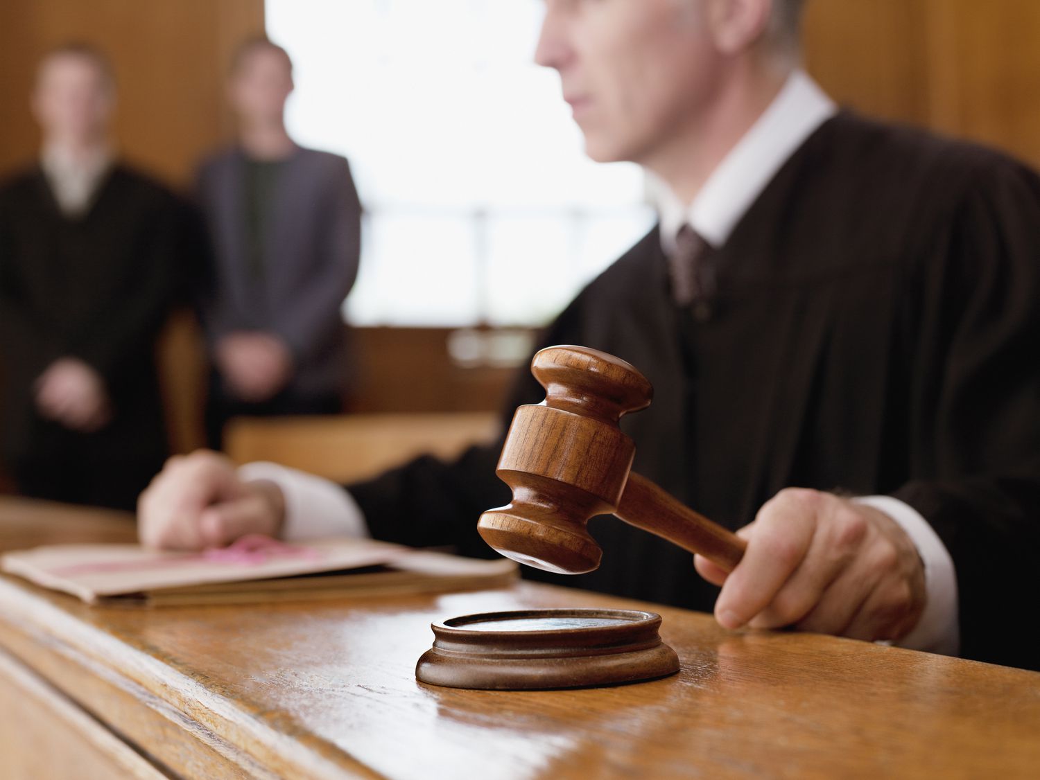 Judge in courtroom with gavel ruling on a civil injury case