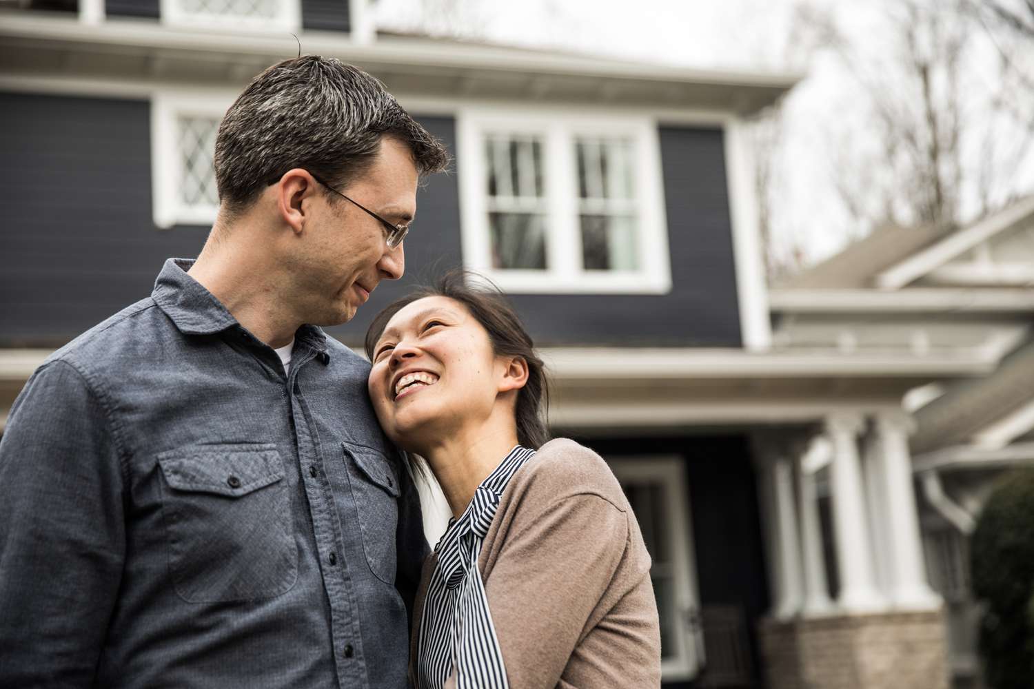Couple standing in front of a house