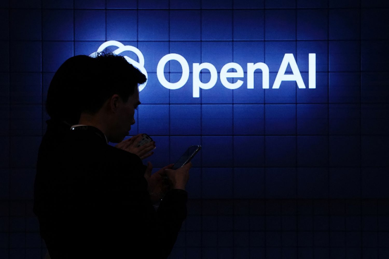 The OpenAI logo on display at a conference.