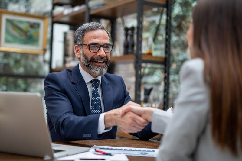 Executives Handshaking in a Coffee Shop