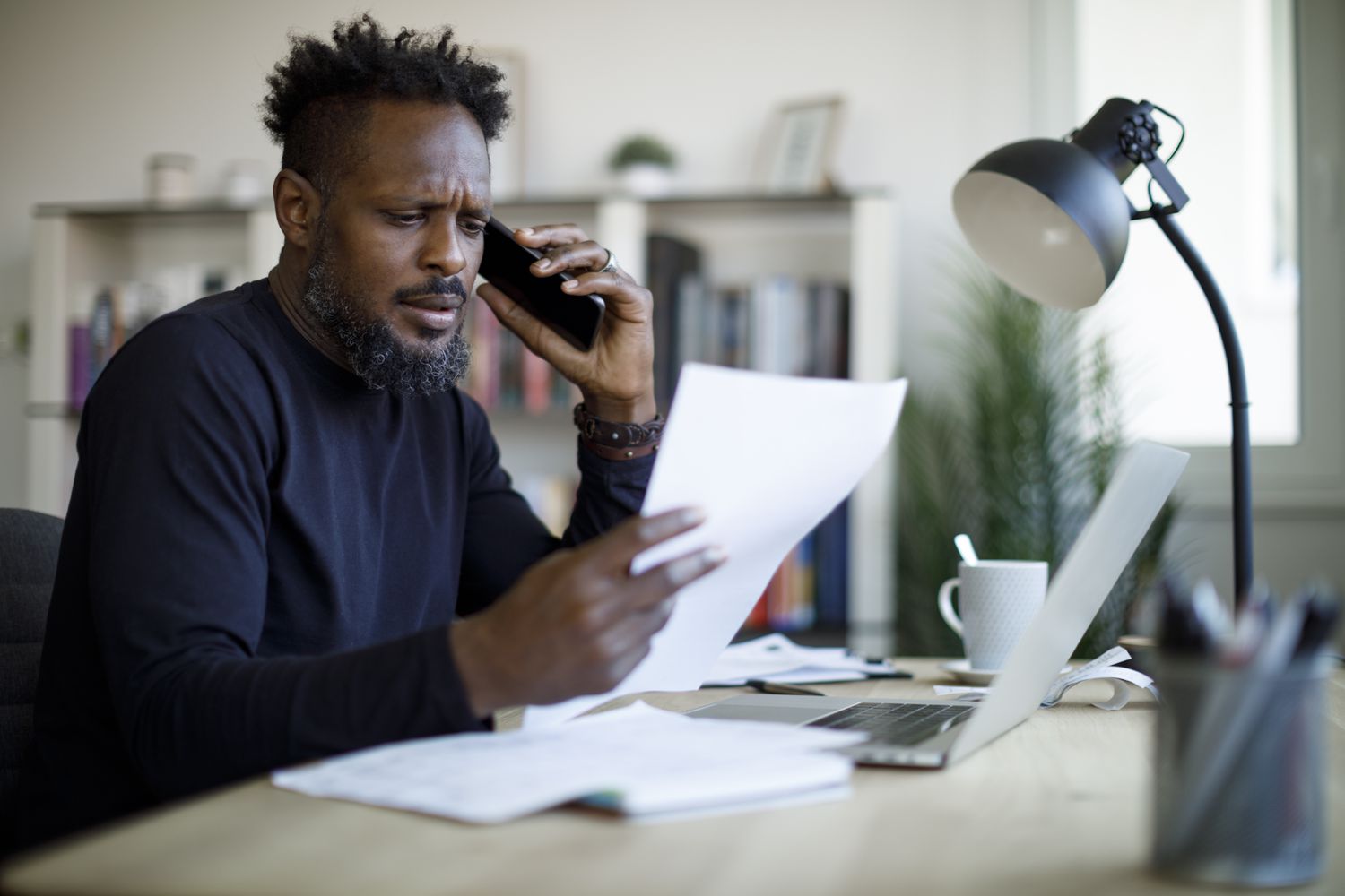 Worried man talking on the phone about his bills