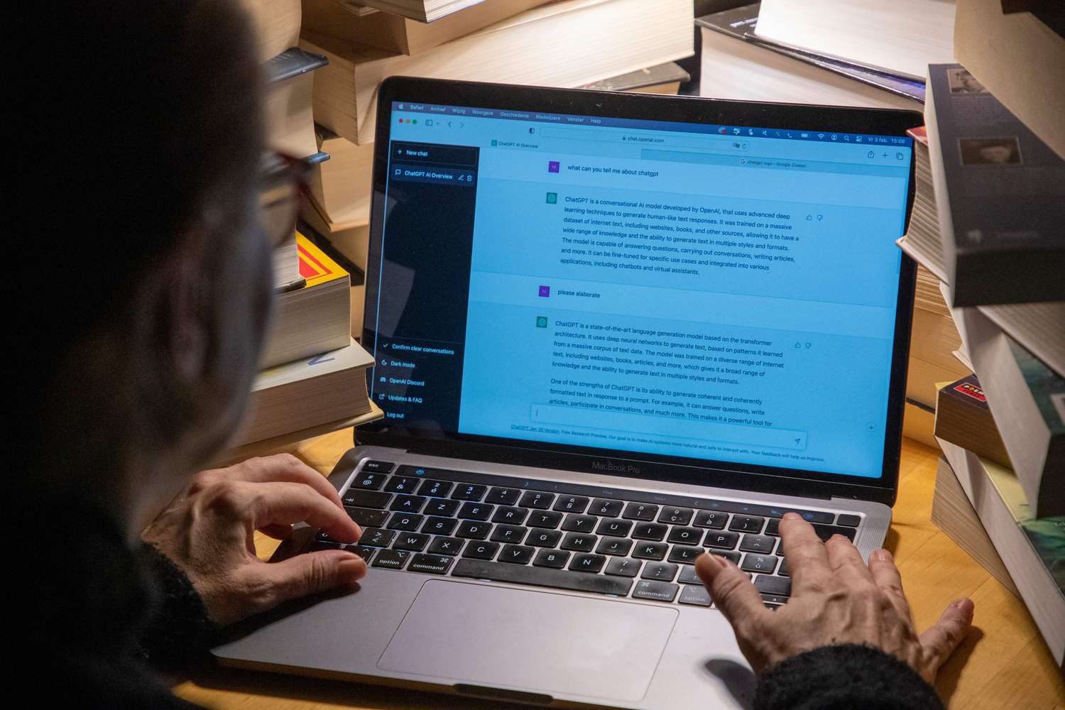 View from behind of a person typing on a computer using ChatGPT
