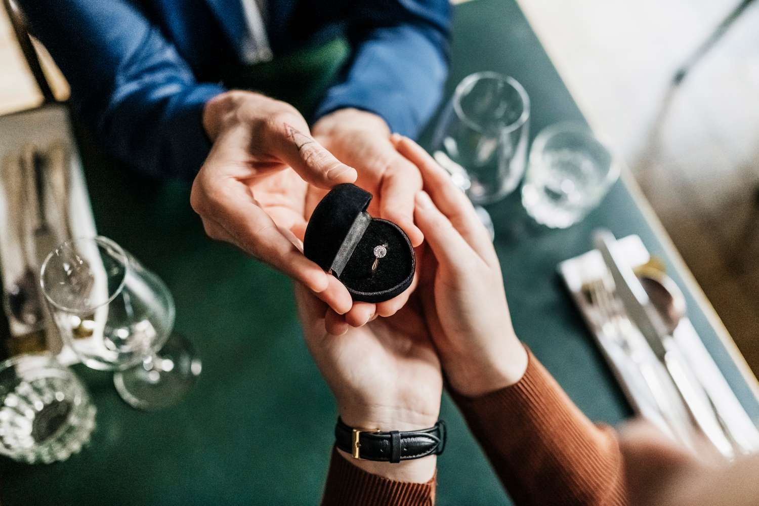 Aerial View Of Man Presenting Girlfriend With Engagement Ring insurance