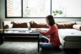 Woman using a laptop at home