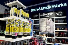 Bath & Body Works products on shelves in a store with the company's logo on the wall