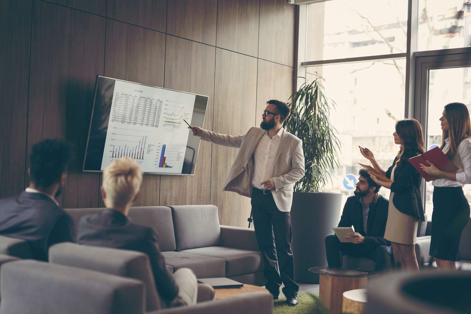 business meeting and presentation using a big monitor in a modern office.