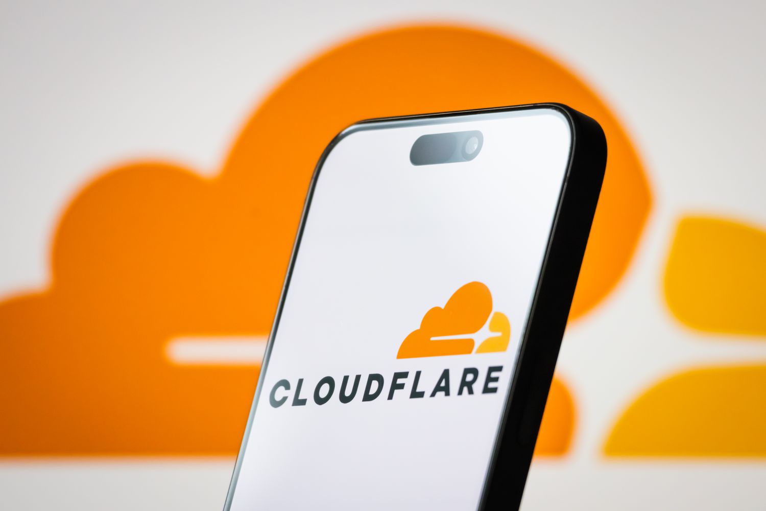The logo of Cloudflare, Inc. is displayed on a smartphone screen, with the company's distinctive orange cloud branding visible in the background