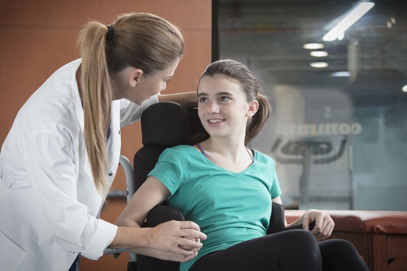 Doctor Comforting Girl in Wheelchair