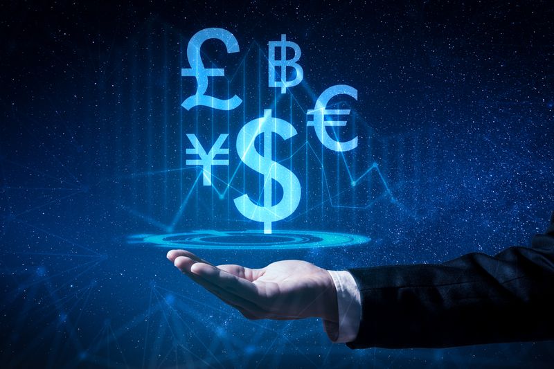 The abstract image of the business man hold the virtual hologram on hand. The concept of currency, financial, online, businessman, information technology and internet of things.
