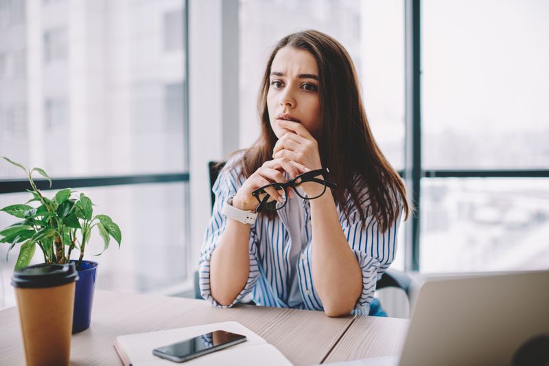 Puzzled young professional pondering financial planning options. 