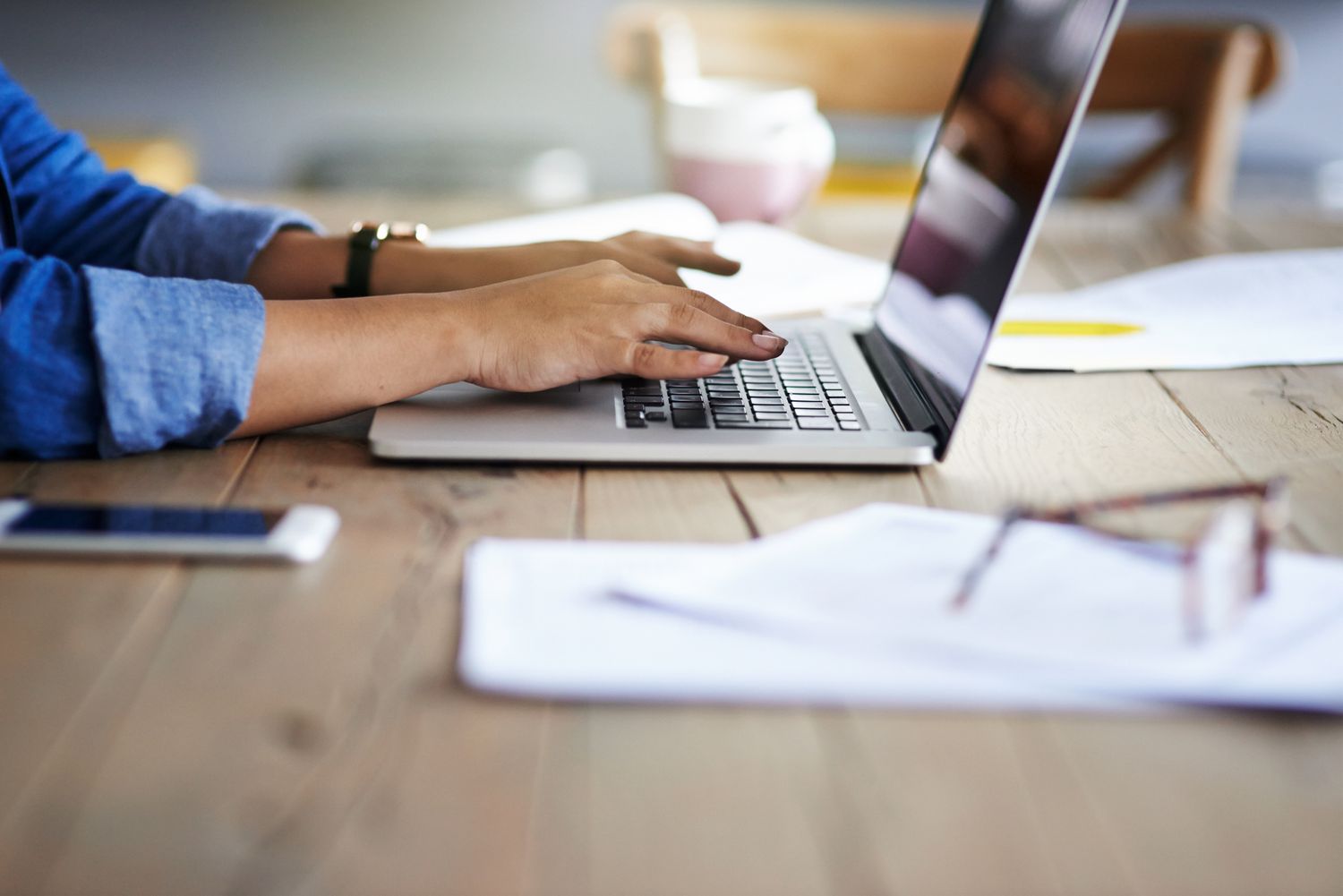 A woman using a laptop while working from home.