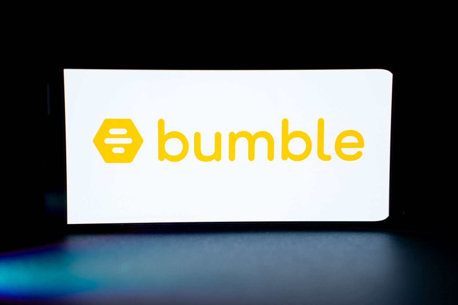 The Bumble dating app logo is being displayed on the screen of a mobile phone