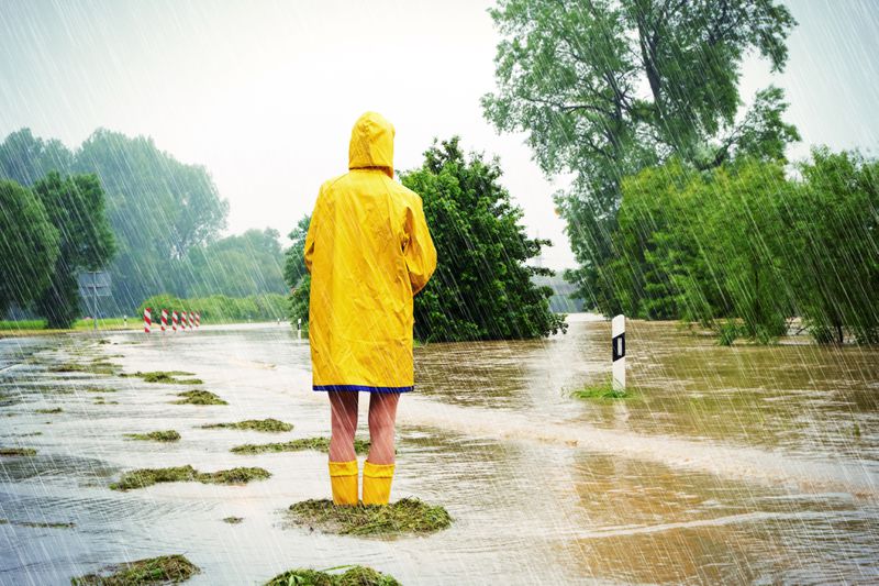 Woman standing in a flooded street.