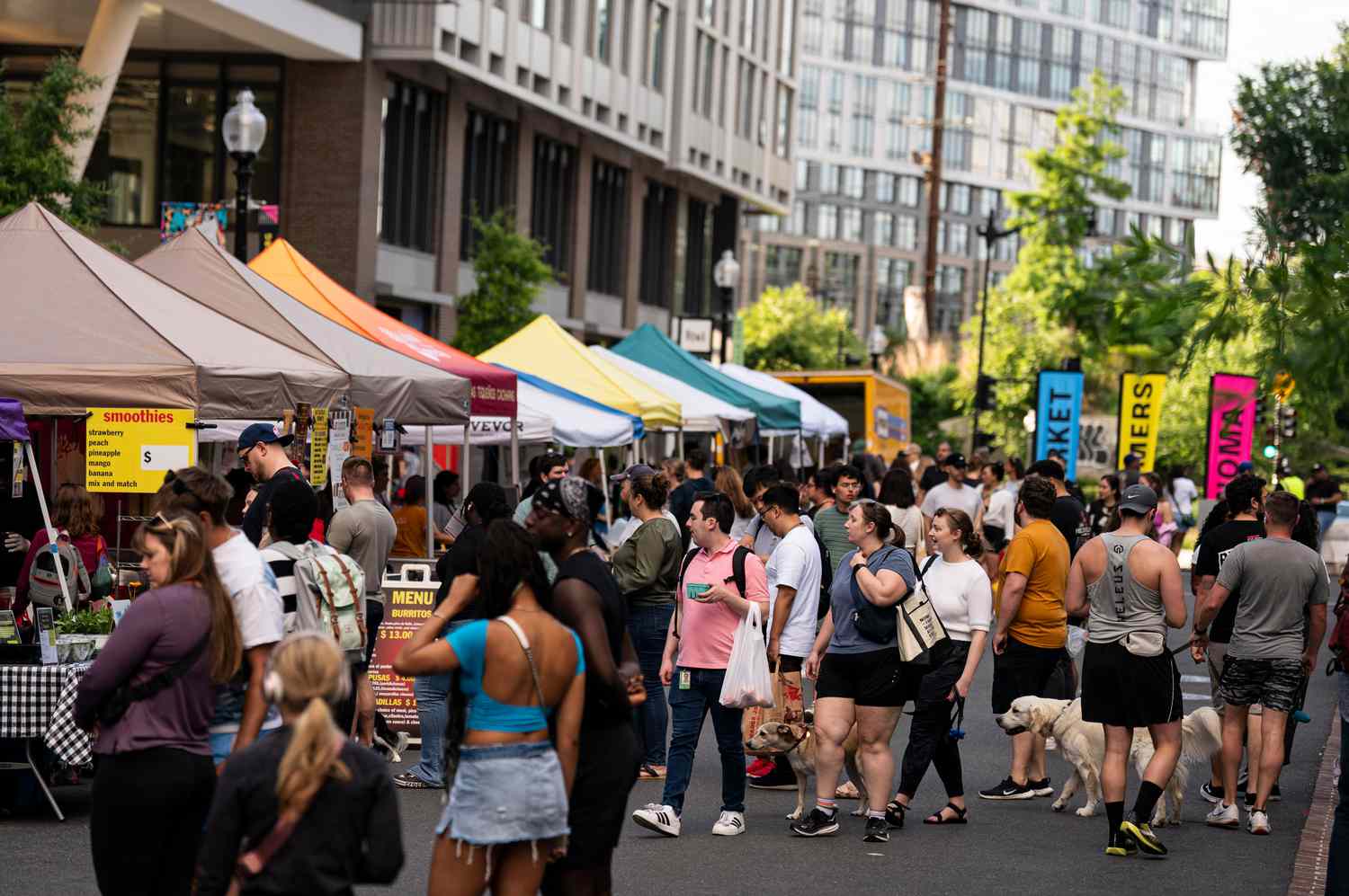 Pedestrians at a farmers market in the NoMa neighborhood of Washington, DC, on May 30, 2024. 