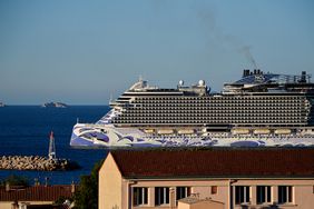 A Norwegian cruise pulls into a port.
