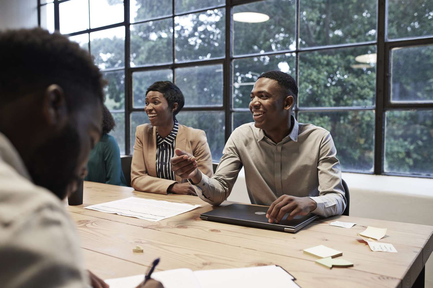 smiling colleagues in an conference room at a workplace