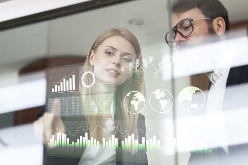 Business Couple Discussing Business Profit on a Modern Interface