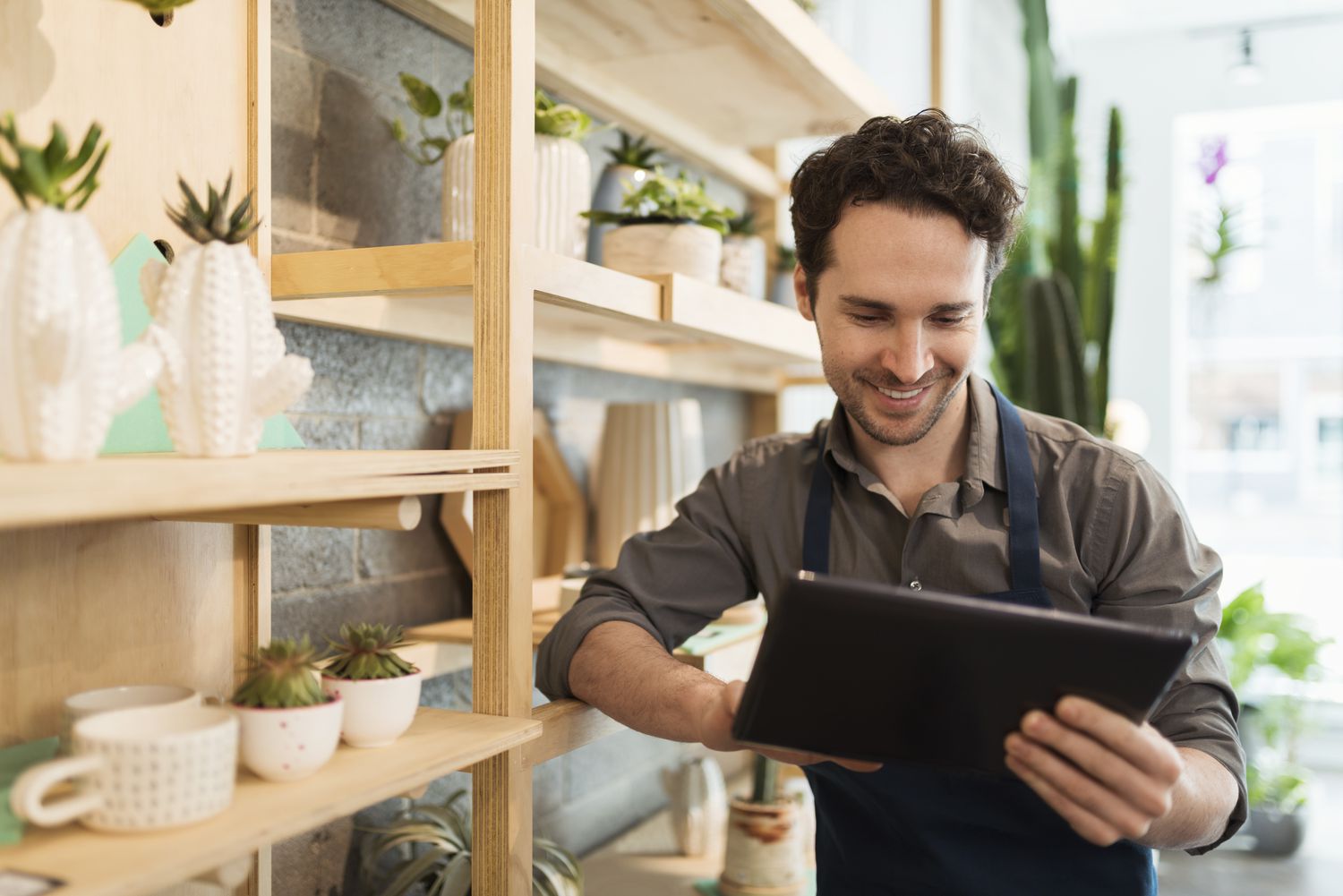 A business owner researching what an MCA loan is on his tablet.