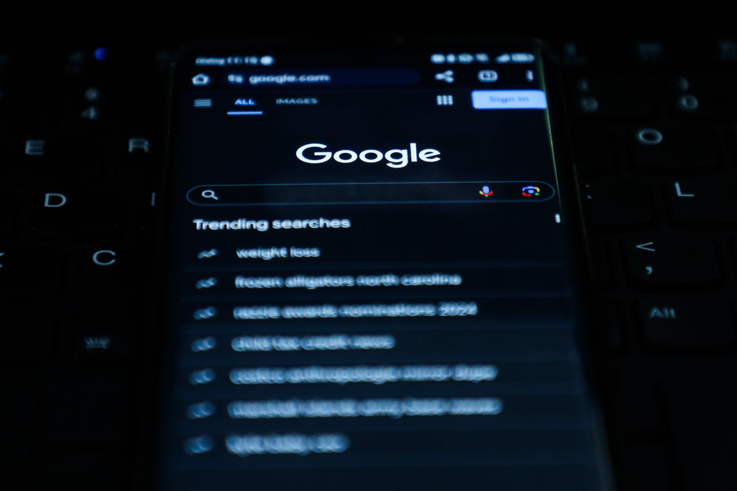 A phone screen shows the Google Search site.