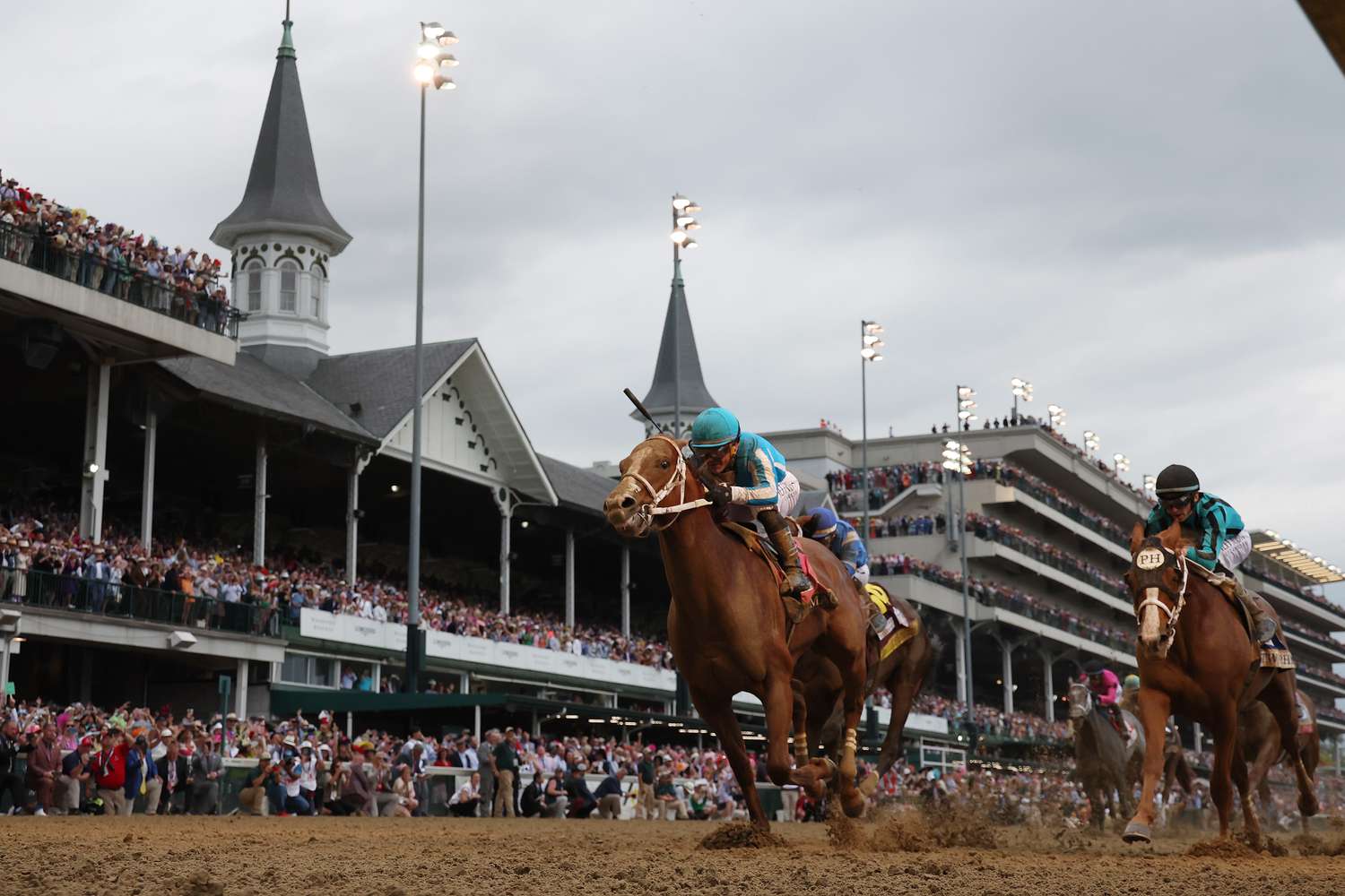 Horses crossing the finish line of the Kentucky Derby at Churchill Downs.
