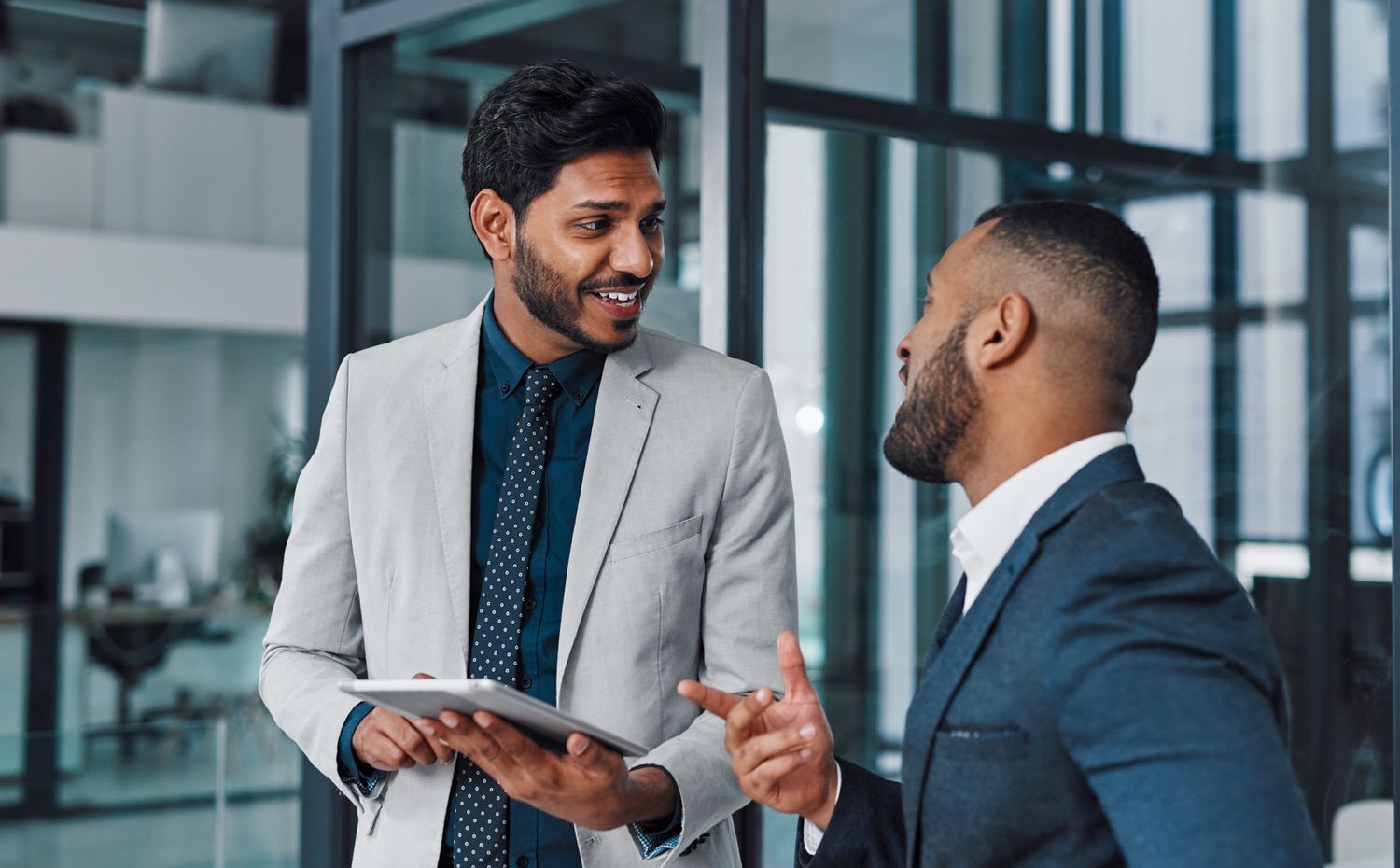 Man talks to his financial advisor about how his mortgage refinancing will affect his FICO score
