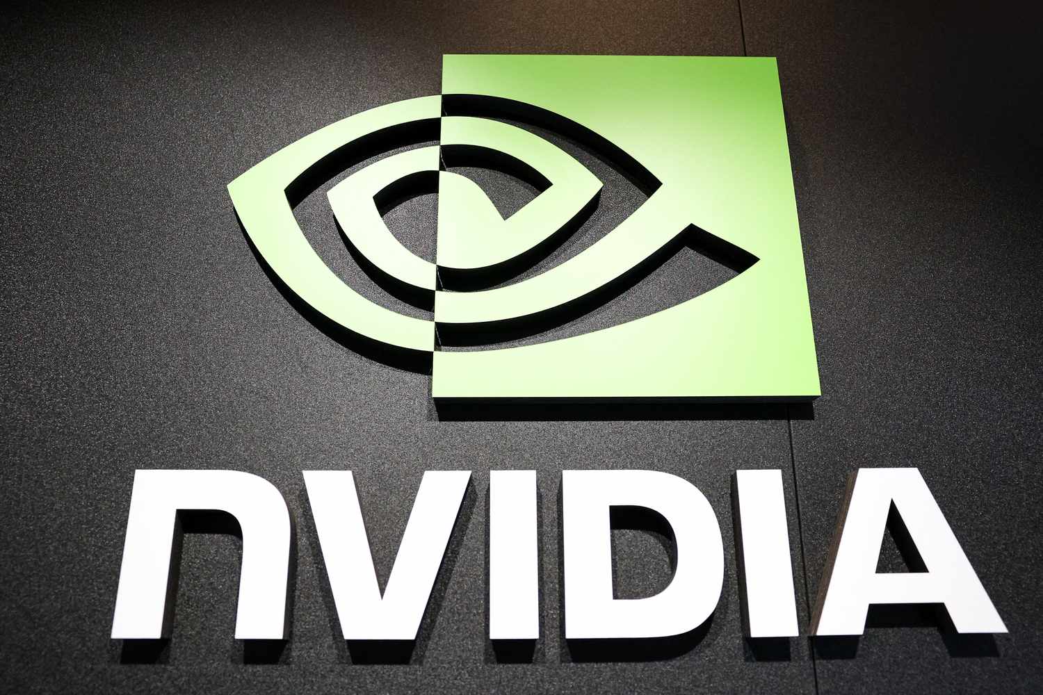 The white and green Nvidia logo is seen on a black wall.
